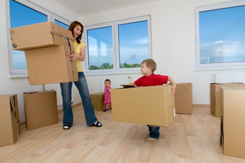 Professional movers carrying furniture through a Wandsworth stairwell